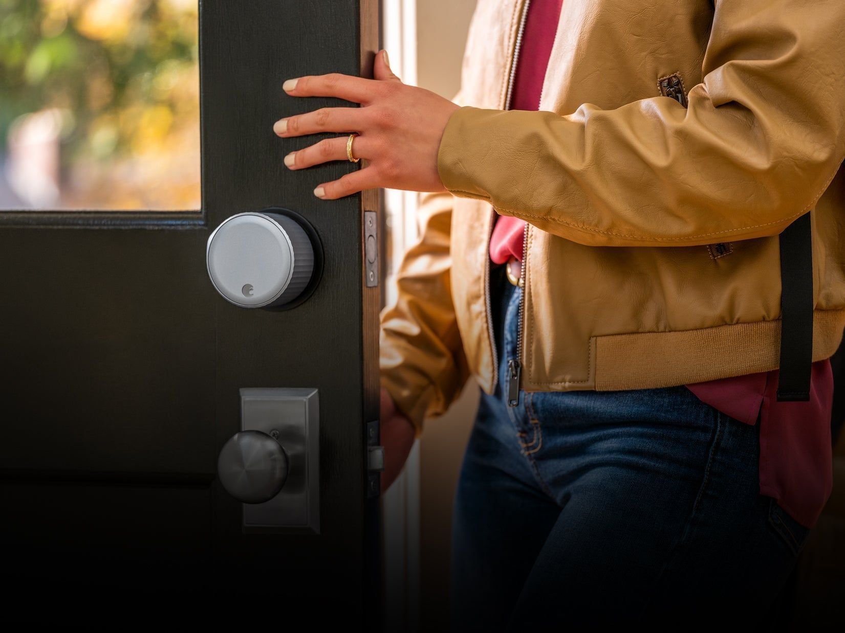 Woman leaving a property with a door that has an August smart lock installed.