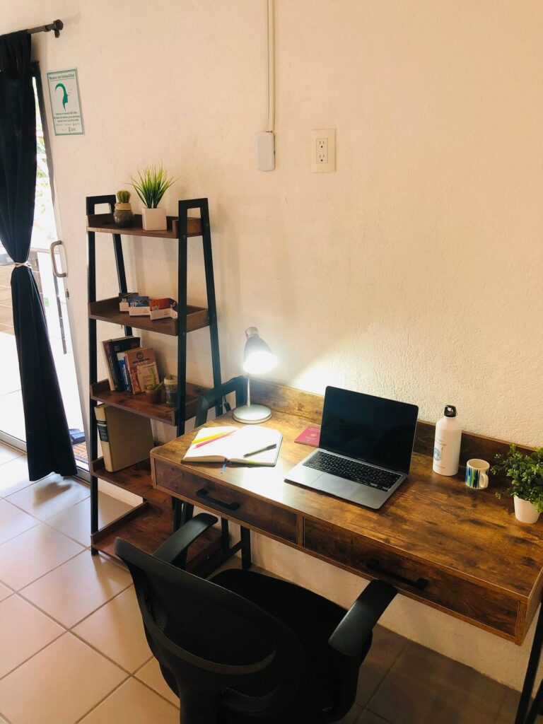 Image of a desk, laptop, and ergonomic chair