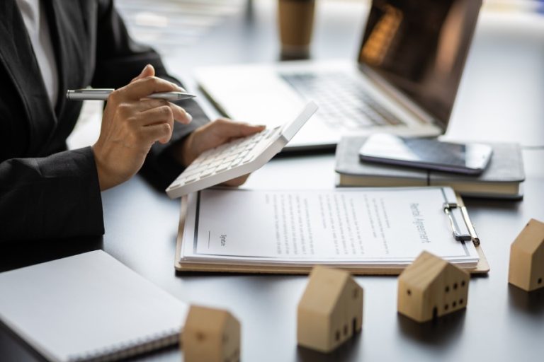 Person calculating potential short term rental management fees