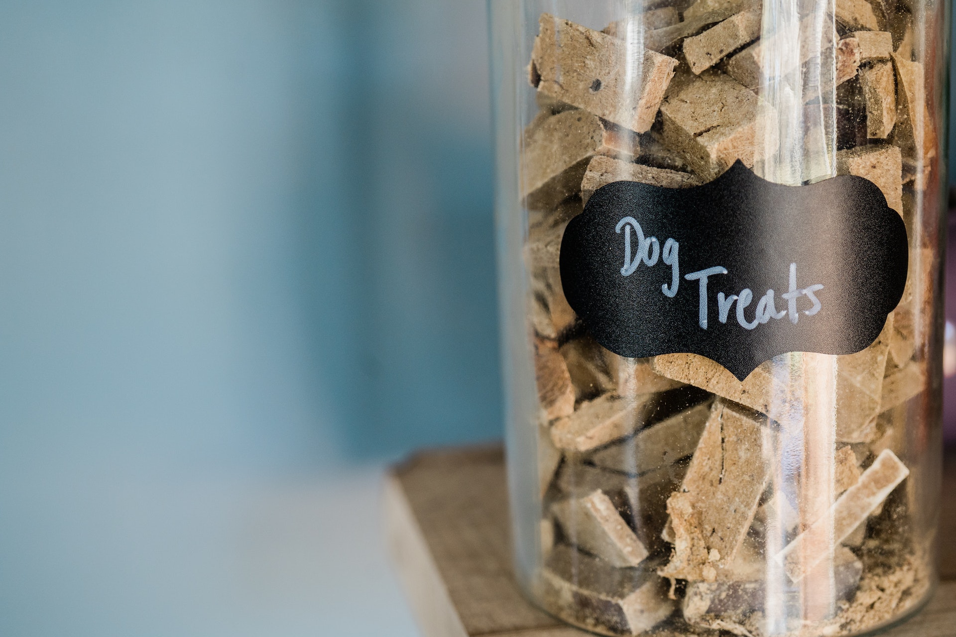 A close-up photo of a glass jar of dog treats.