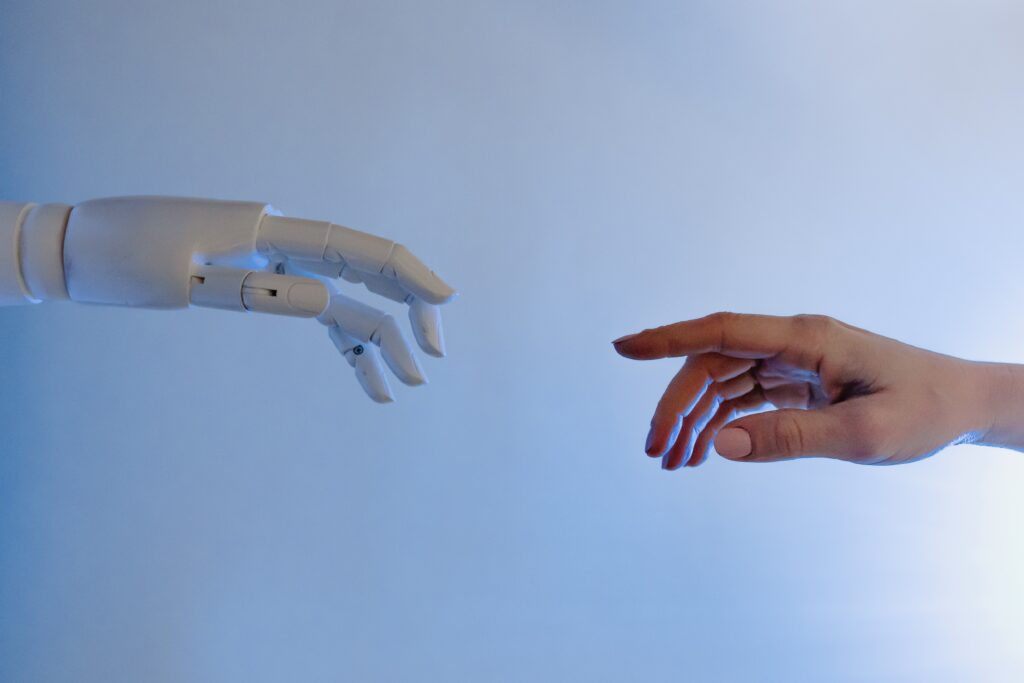 Robot hand and human hand recreating 'the creation of adam' photographed by Tara Winstead