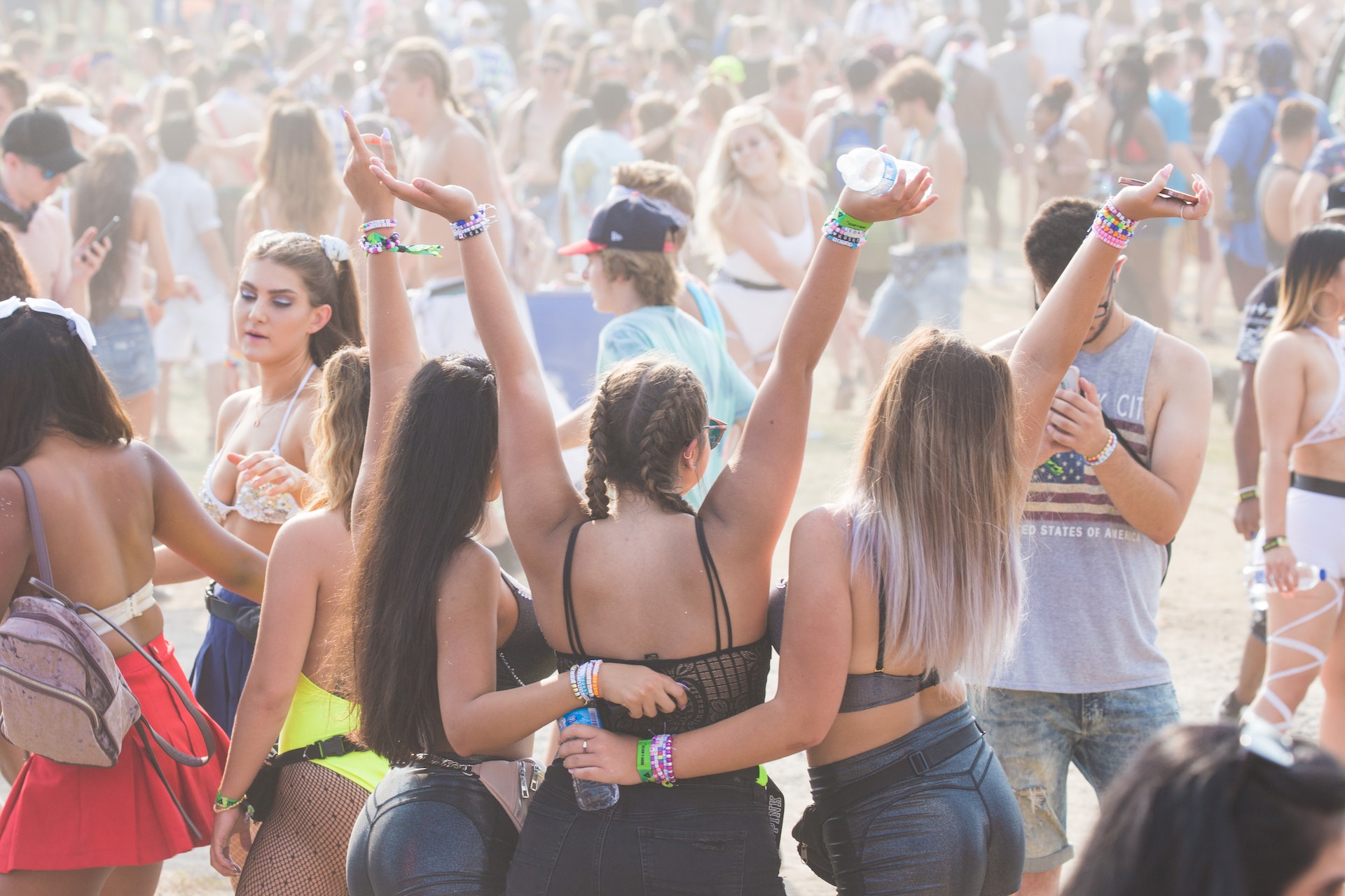A photo of revelers having a good time at an outdoor music festival