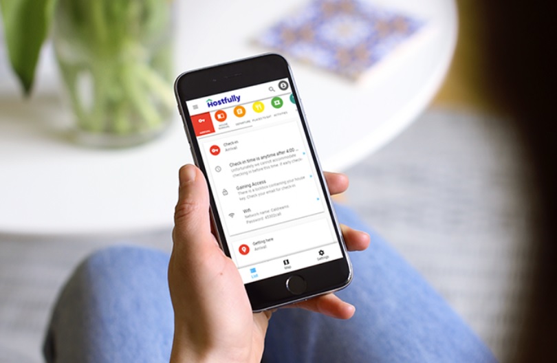 Someone looking at a Hostfully Digital Guidebook on a smartphone screen.