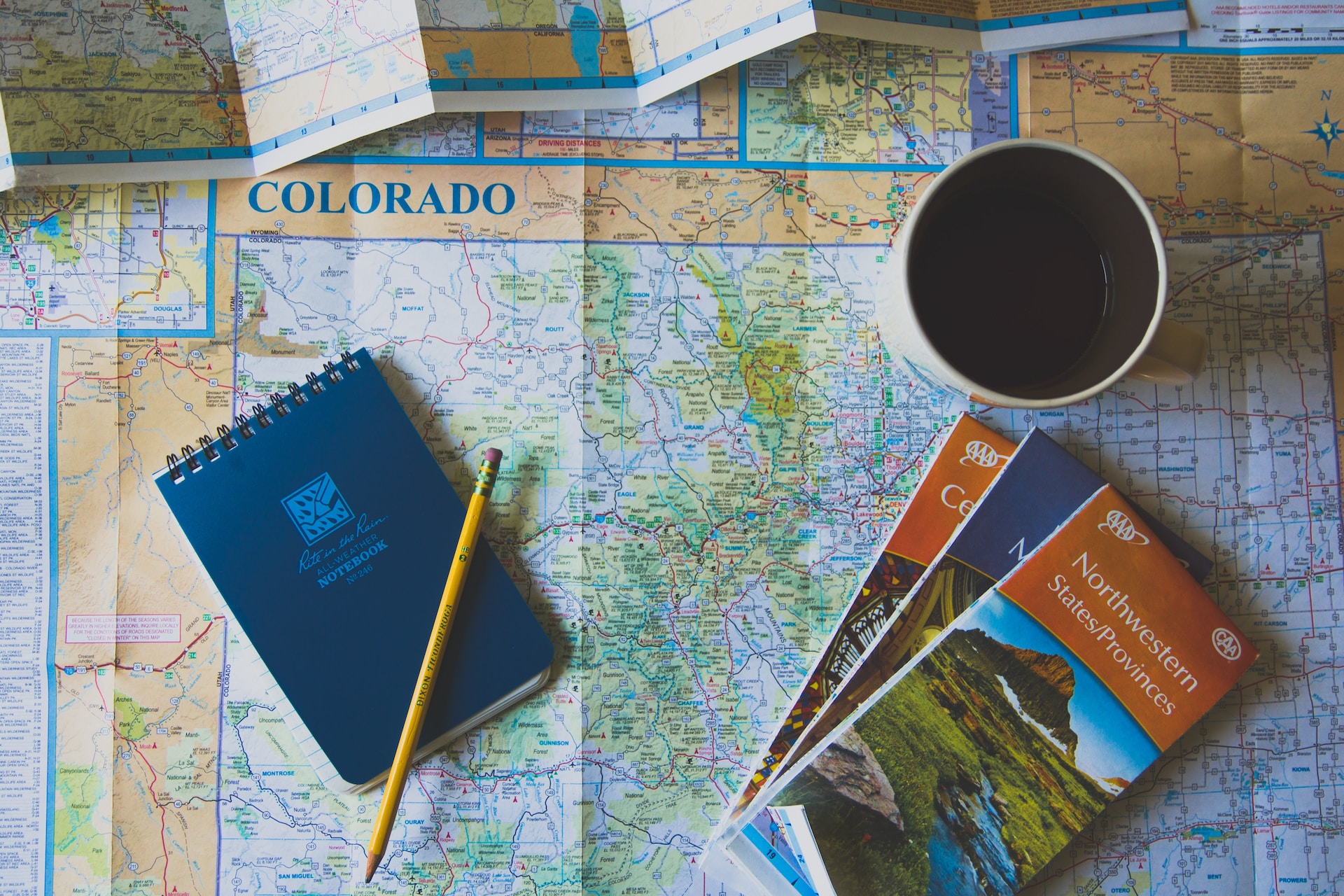 A view from above of a map of Colorado and maps on exploring the state.