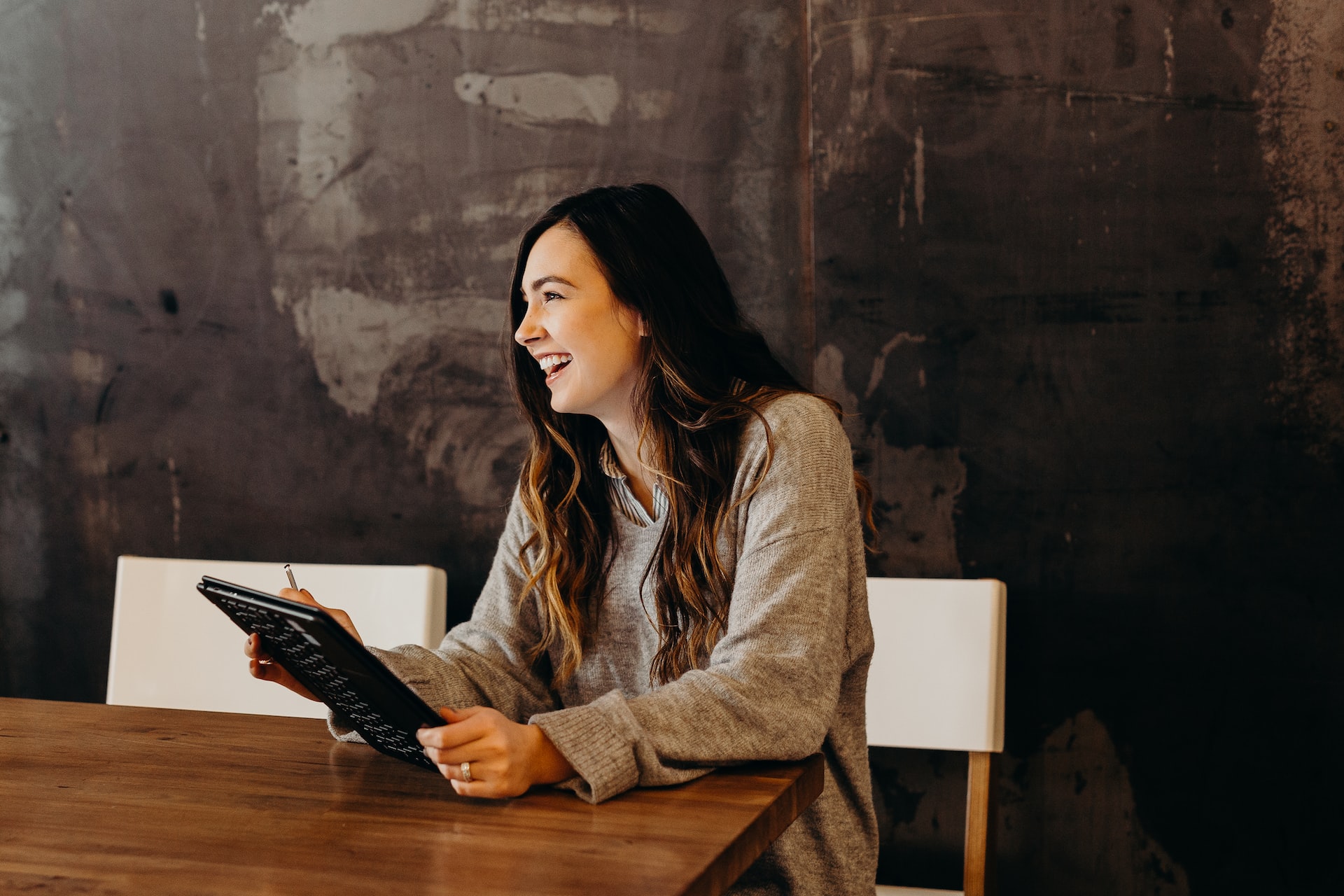 A woman using a tablet looking happy