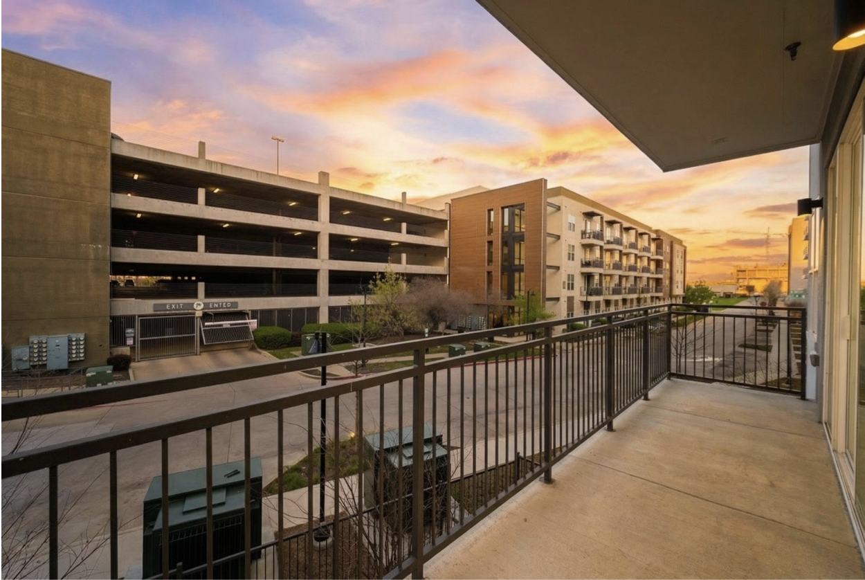 Apartment building with a sunset behind it